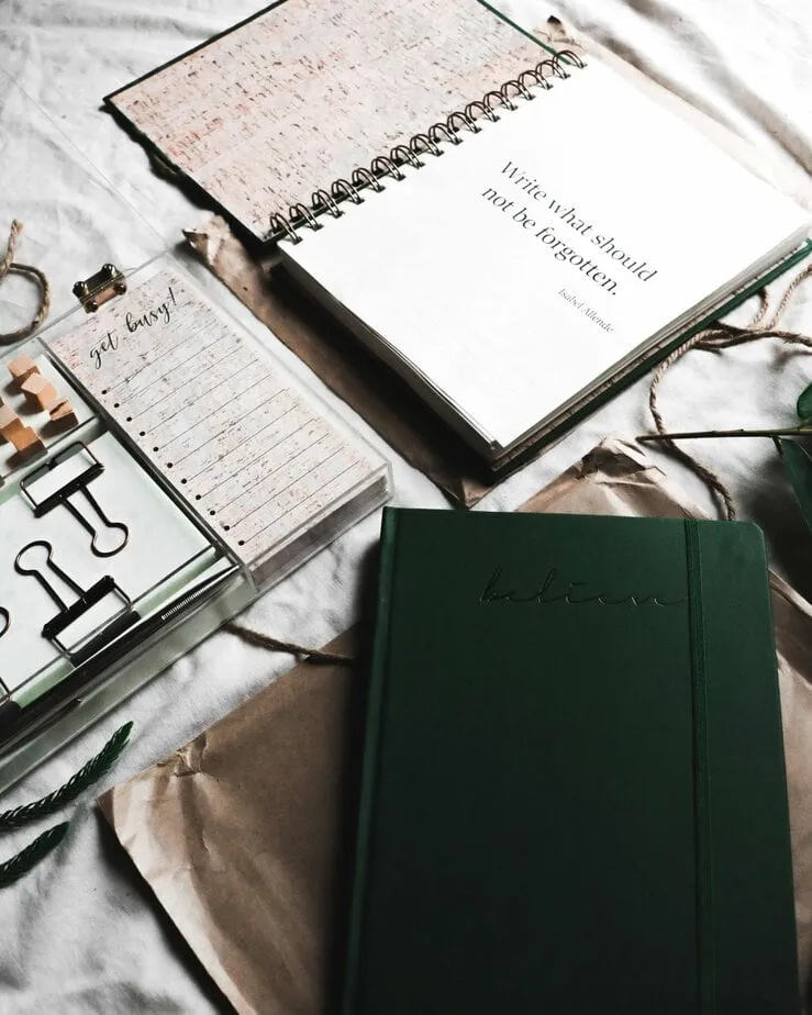 A journal and pen on a wooden desk
